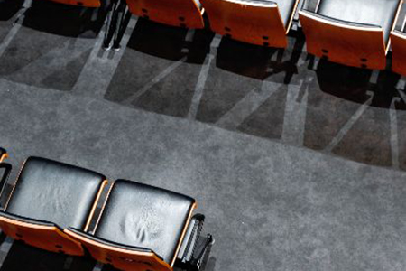 Vacant chairs arranged neatly in an auditorium, ready to accommodate attendees for a gathering or presentation.