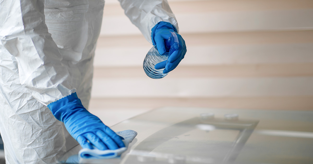 cleaning services provider cleaning a table with spray cleaning services provider cleaning a table with spray