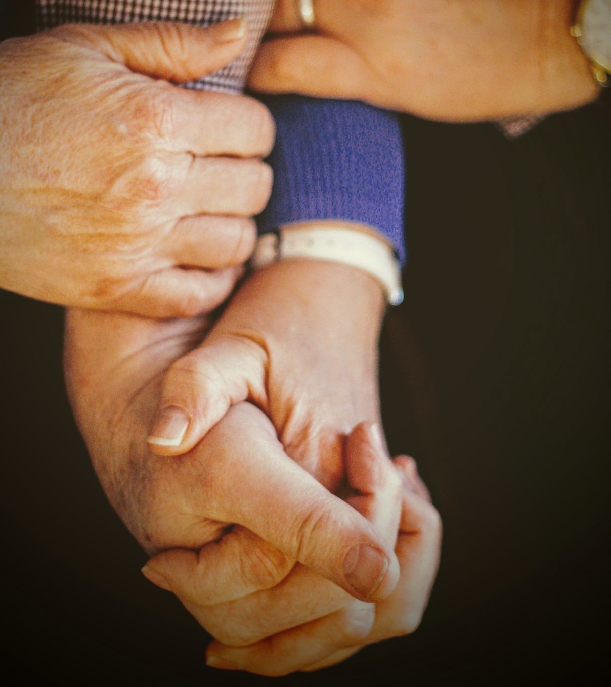 A tender moment captured as an elderly couple intertwines their hands, symbolizing enduring unity and devotion. A tender moment captured as an elderly couple intertwines their hands, symbolizing enduring unity and devotion.