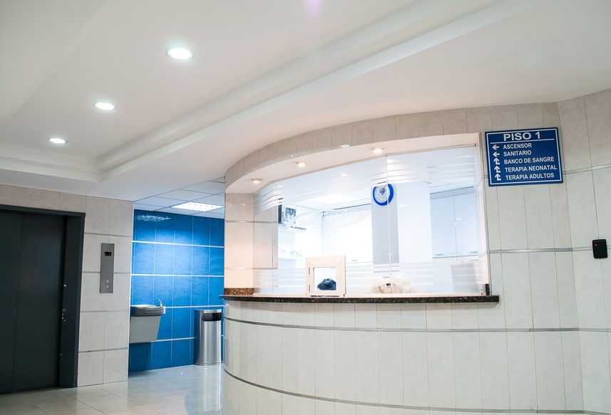 Professional reception area with white and blue decor and a striking blue wall. Professional reception area with white and blue decor and a striking blue wall.