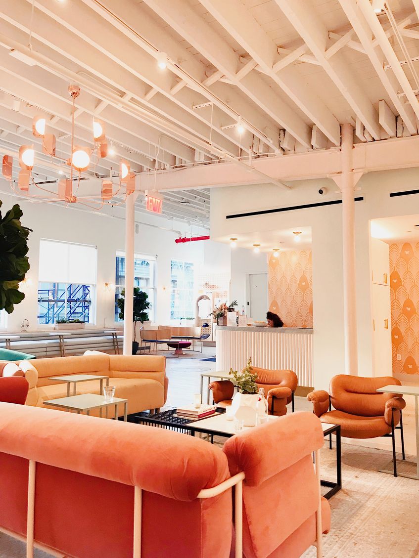 Professional office space featuring vibrant orange furniture and a spacious white ceiling Professional office space featuring vibrant orange furniture and a spacious white ceiling