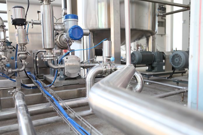 A complex industrial apparatus with numerous pipes and valves for efficient operation. A complex industrial apparatus with numerous pipes and valves for efficient operation.