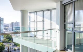 Sydney apartment with balcony, blinds, and large windows that require special cleaning